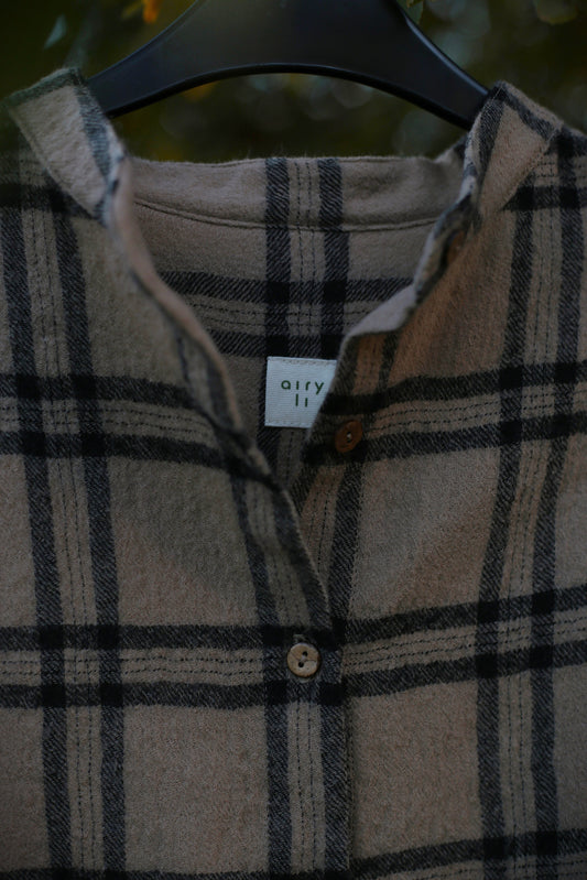 Plaid shirt with a brand label on a hanger